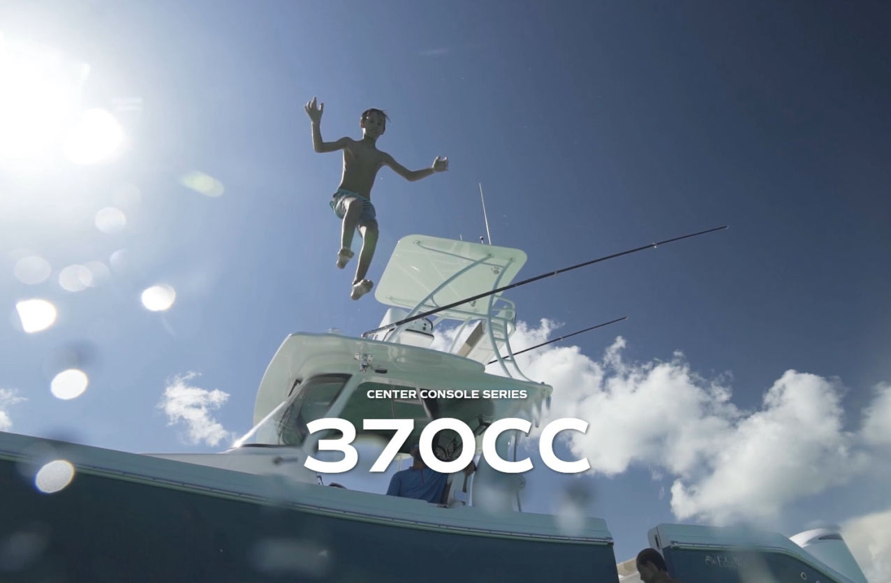 EdgeWater 370CC cruising in the Arabian Gulf at sunrise with the Dubai skyline in the background.